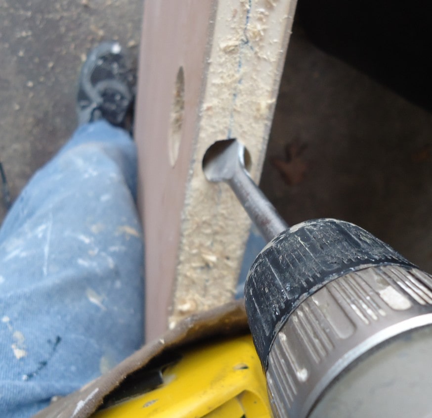 Drilling hole in wood with a spade bit.